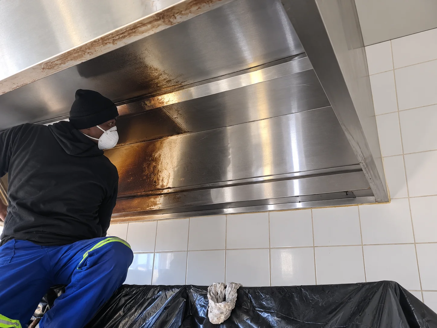 SBS technician cleaning a restaurant kitchen extraction duct on site